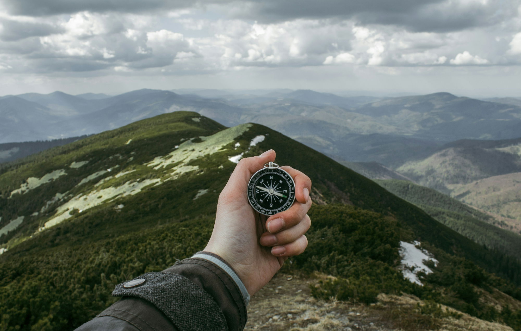person-holding-silver-compass.jpg person holding silver compass